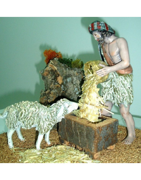 Pastor dando de comer a cordero en establo barro lienzado 20 cm. 20.5908.16.